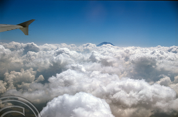 T015999. Mt Agung pokes through the clouds. Seen from a departing plane. Bali. Indonesia. 21st September 2003