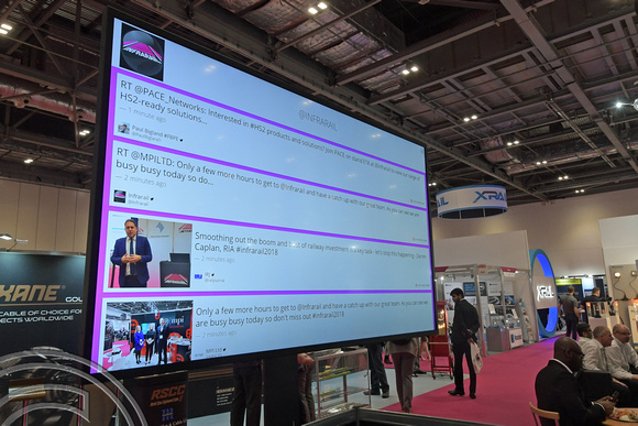 DG295479. Watching tweets about the show. Infrarail 2018. London. 3.5.18