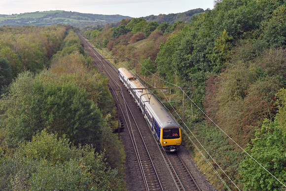 DG404434. 323235. 2G14. 1233 Manchester Piccadilly to Hadfield. Passes the remains of Mottram Staff Halt. 12.10.2023.