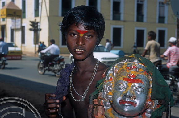 T12985. Young boy begging with a Hindu shrine. Panjim. Goa. India. 5th February 2002