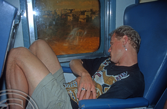 T5902. John asleep on the train. Karnataka. India. January 1996.
