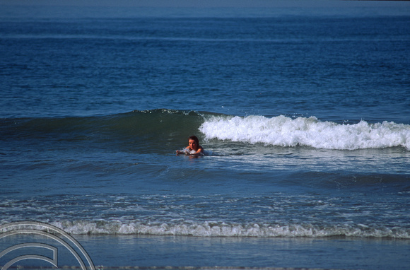 T5922. Lynn playing in the waves. Arambol. Goa. India. January 1997