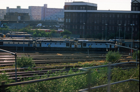 06734. 33033. 33042. View of the depot from a passing train. Stewarts Lane. June 97