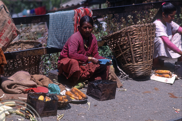 T6973. Woman selling cooked corn on the cob. Darjeeling. West Bengal. India. April.1998.
