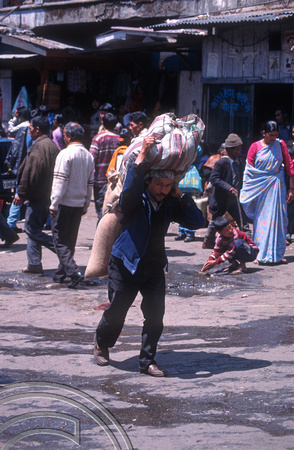 T6981. Porter with sacks. Darjeeling. West Bengal. India. April.1998.
