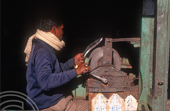 T6989. Sharpening a Kukri. Darjeeling. West Bengal. India. April.1998.