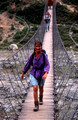 T7075. Lynn on a suspension bridge Nth of Gorkha. Gorkha. Nepal. April.1998.