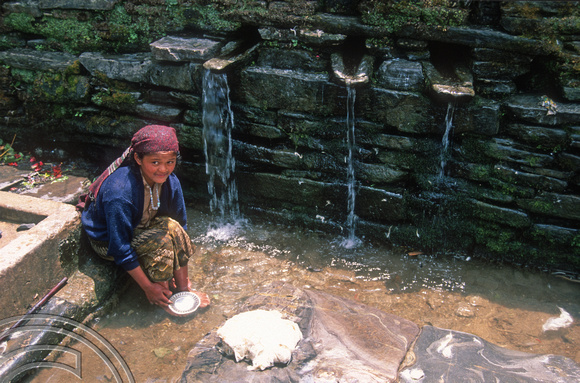 T7116. Young girl doing her washing. Barpak. Gorkha district. Nepal. April.1998.
