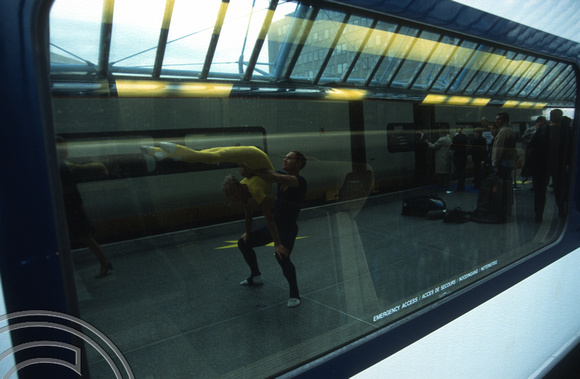 13049. Acrobats reflected in the windows of a Eurostar. Waterloo International. 27.09.2003