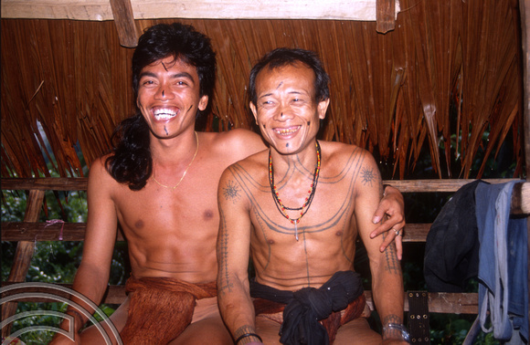 T03793. Joni and our host in traditional clothing. Siberut. Mentawai Islands. Indonesia. 19th June 1992
