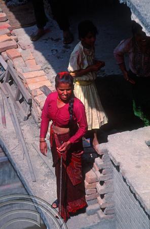 T03329. Nepali woman watching the fun on Holi. Thamel. Kathmandu Valley. Nepal. 18th March 1992