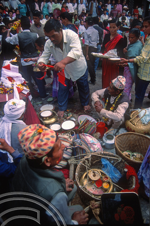 T03370. Making offerings at a festival in Durbar Square. Kathmandu. Nepal. March 1992