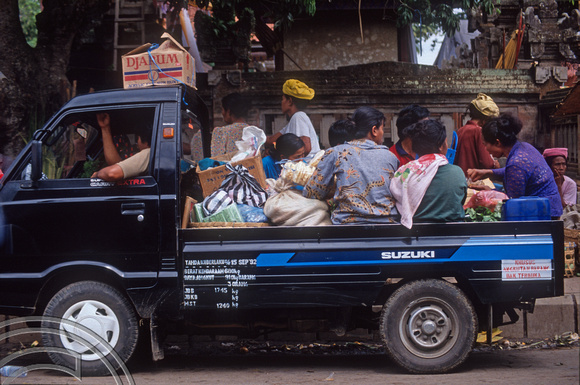 T03980. Crowding into the back of a pickup. Ubud. Bali. Indonesia. August 1992