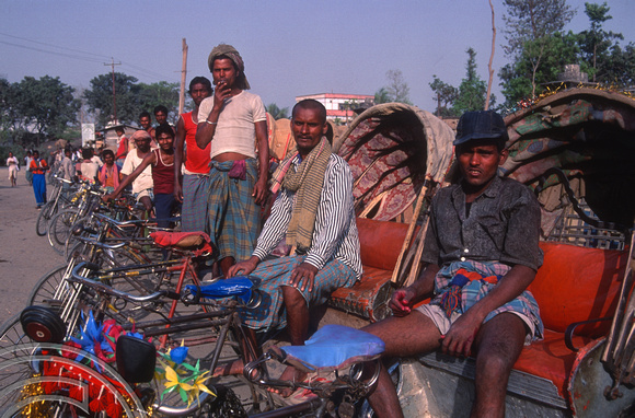 T03260. Pedal rickshaws in a line. Janakpur. The Terai. Nepal. 9th March 1992