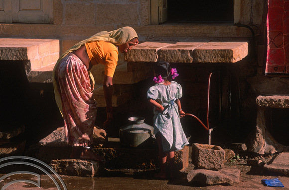 T02991. Woman and girl fetching water. Jaisalmer. Rajasthan. India. 3rd November 1991