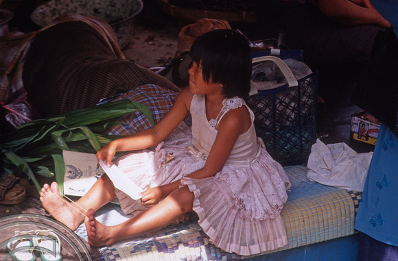 T03645. Girl on her father's stall. The market. Bukittinggi. West Sumatra. Indonesia. 3rd June 1992