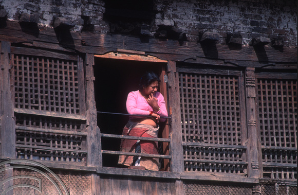 T03270. Woman at a window. The Monkey Temple. Kathmandu. Nepal. 12th March 1992