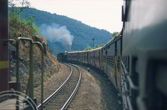 T03079. Vasco-Bangalore train banked by a steam engine 30154. Dudhsagar. Goa. India. December 1991.