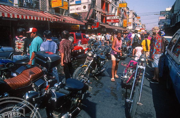 T03392. Motorcycles parading. Khao San Rd. Bangkok. Thailand.  12th April 1992