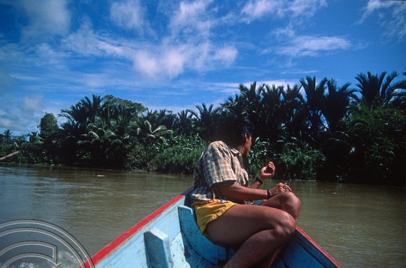 T03735. Going inland by canoe. Looking out for obstructions. Siberut. Mentawai Islands. Indonesia.  16th June 1992
