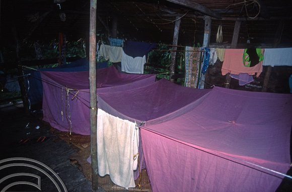 T03742. Mosquite nets set up in an Uma. Siberut. Mentawai Islands. Indonesia. June 1992