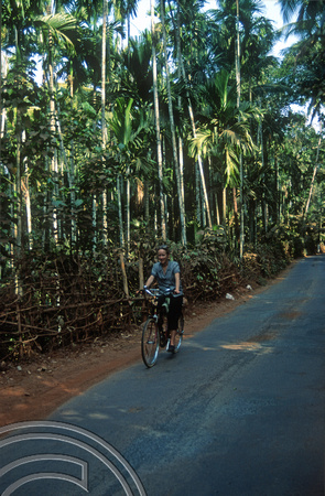 T03075. Wendy cycling. Pernem. Goa. India. December 1991.