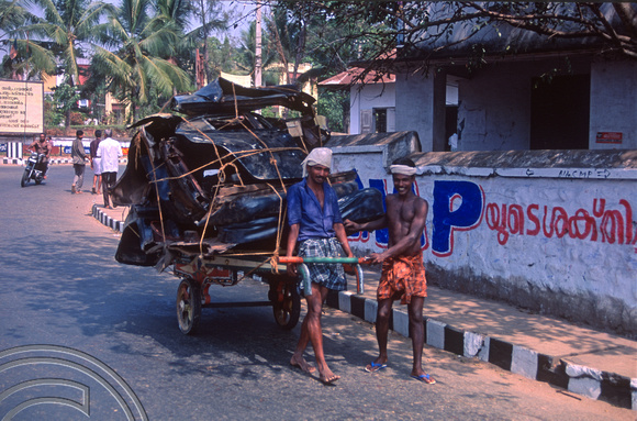 T03151. Crushed taxi on a cart. Trivandrum. Kerala. India. 1st February 1992.