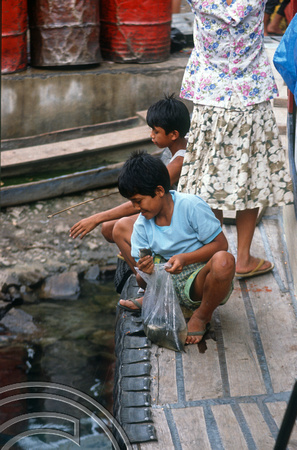 T03597. Children fishing froma boat. Prapat. Samosir Island. Lake Toba. North Sumatra. Indonesia. 30th May 1992