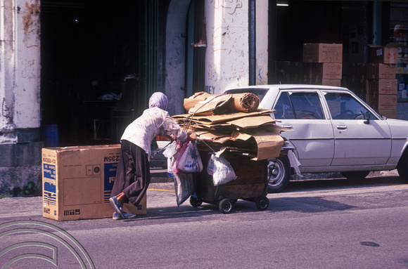 T03568. Beggar collecting cardboard boxes. Georgetown. Penang. Malaysia. 16th May 1992