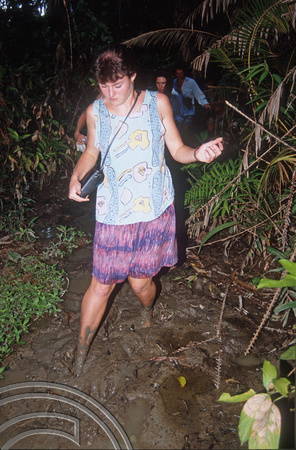 T03807. Sue trekking through the mud. Mentawai Islands. Indonesia. 21st June 1992