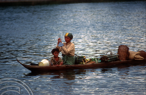 T03837. Woman and child in a canoe. Siberut. Mentawai Islands. Indonesia. 22nd June 1992