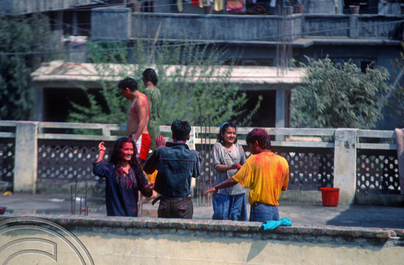 T03328. Nepali family having fun on Holi. Thamel. Kathmandu Valley. Nepal. 18th March 1992