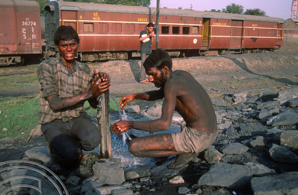 T02966. Washing after loading coal by hand at the loco depot. Jaipur. Rajasthan. India. 30th October 1991