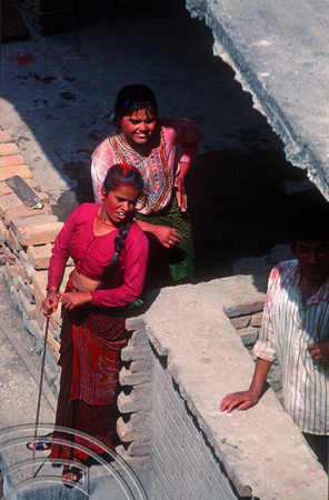 T03330. Nepali woman watching the fun on Holi. Thamel. Kathmandu Valley. Nepal. 18th March 1992