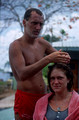 T04141. Phil cutting Alex's hair. Ivans backpackers. Darwin. Northern Territory. Australia.  September 1992