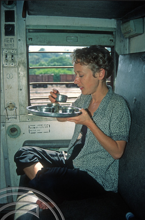 T03086. Wendy eating on the Vasco-Bangalore train. Goa. India. December 1991.