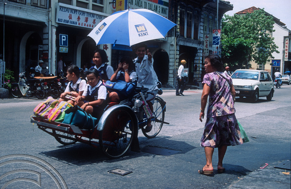 T03509. Schoolkids in a rickshaw. Lebuh Chulia. Georgetown. Penang island. Malaysia. 5th May 1992