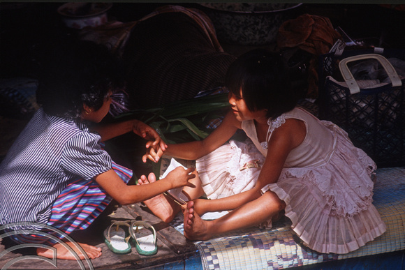 T03644. Young girls on a stall. The market. Bukittinggi. West Sumatra. Indonesia. 3rd June 1992