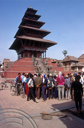 T03297. Buildings and crowds around a Sadhu. Bakhtapur. Kathmandu Valley. Nepal. 13th March 1992