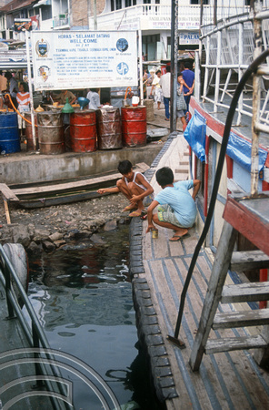 T03596. Children fishing froma boat. Prapat. Samosir Island. Lake Toba. North Sumatra. Indonesia. 30th May 1992