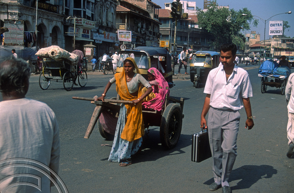 T03040. Woman pulling a cart. Ahmedabad. Gujarat. India. 12th November 1991
