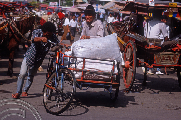 T03640. Moving goods by cycle power. The market. Bukittinggi. West Sumatra. Indonesia. 3rd June 1992