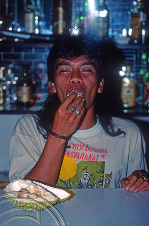 T03860. Joni eating durian at the Rondezvous. West Sumatra. Indonesia. 24th June 1992