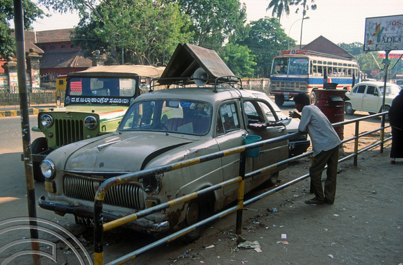T03145. Old car used as a lottery booth. Mangalore. Karnataka. India. 28th January 1992.