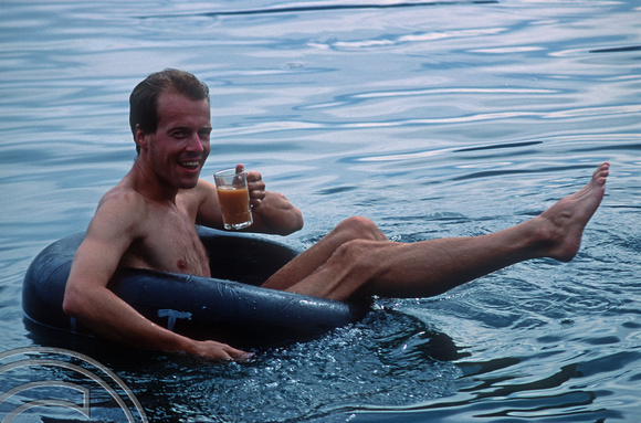 T03652. Tony floating on a tube. Lake Maninjau. West Sumatra. Indonesia.  June 1992