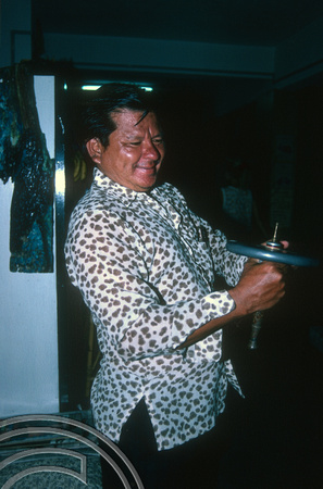 T03539. Benny Hill with a spinning top. Menora guest house. Kota Baru. Kelantan. Malaysia. 12th May 1992