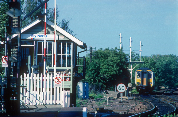 01257. Ely North signalbox and semaphore signals. 156413 in background. Ely. 08.07.1990