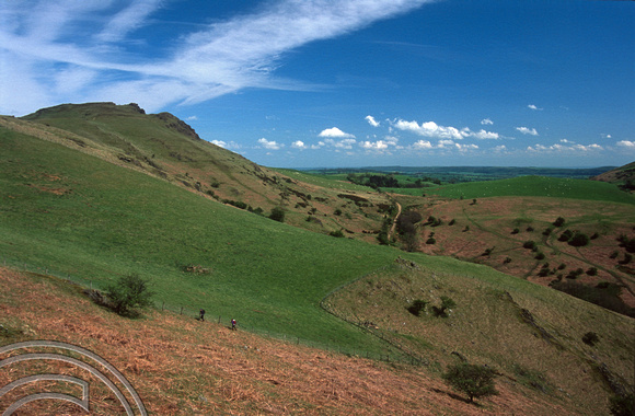 T15474. Walkers on Caer Caradoc, being battered by the wind. Shropshire. 04.05.2003