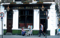 T15589. Couple outside the James Gleeson bar on O'Connell St. Limerick. Ireland. 14.06.2003
