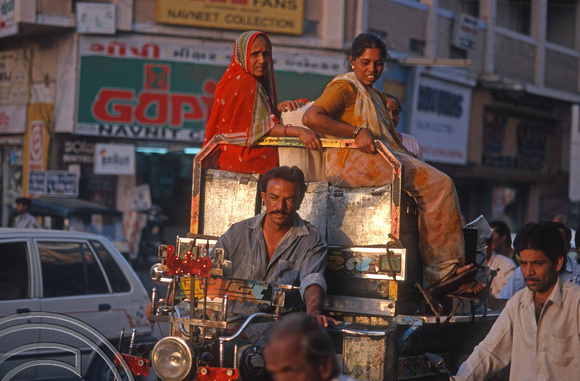T9638. Women sit atop sacks on a motor rickshaw. Rajkot. Gujarat. India. 11.02.2000crop